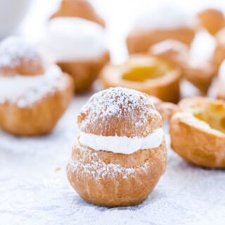 a gluten free cream puff topped with powdered sugar ready to serve