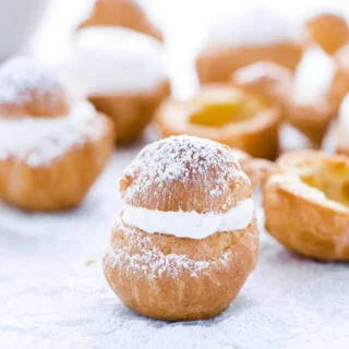 a gluten free cream puff topped with powdered sugar ready to serve