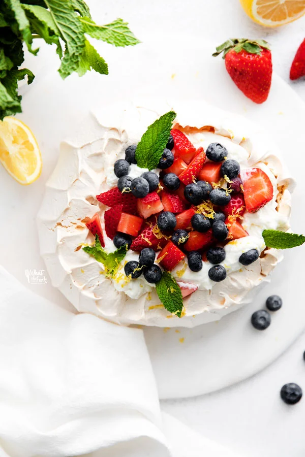 overhead shot of a pavlova on a white plate