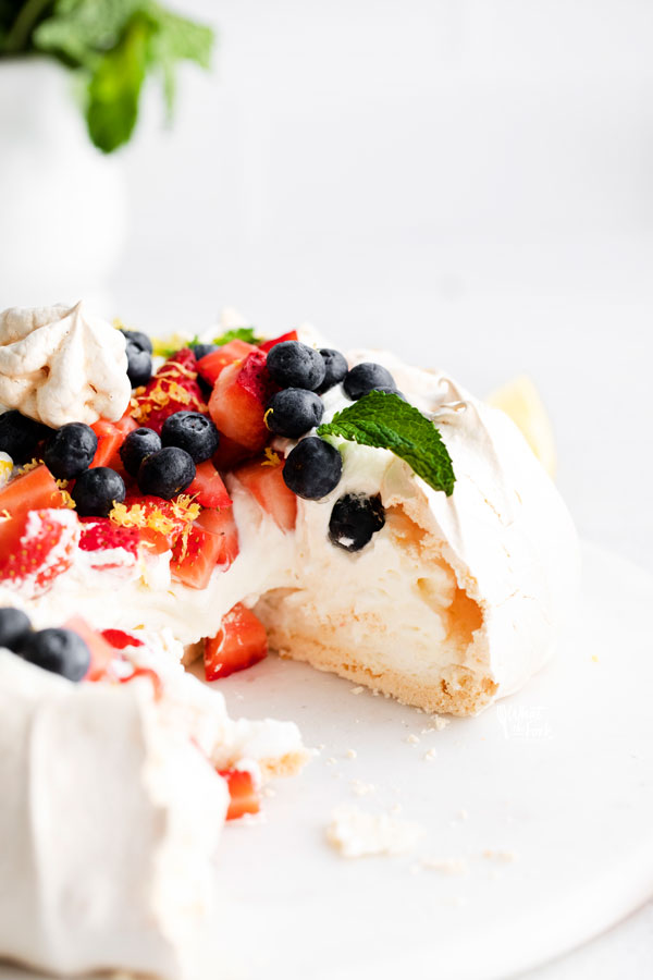 a classic pavlova that has been cut into to be served