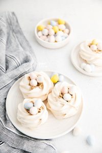 Easter Meringue Nests on a white plate with Mini Cadbury Eggs