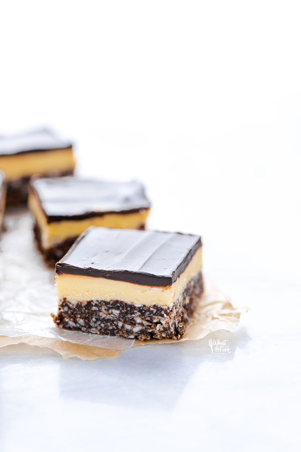 sliced Gluten Free Nanaimo Bars on parchment