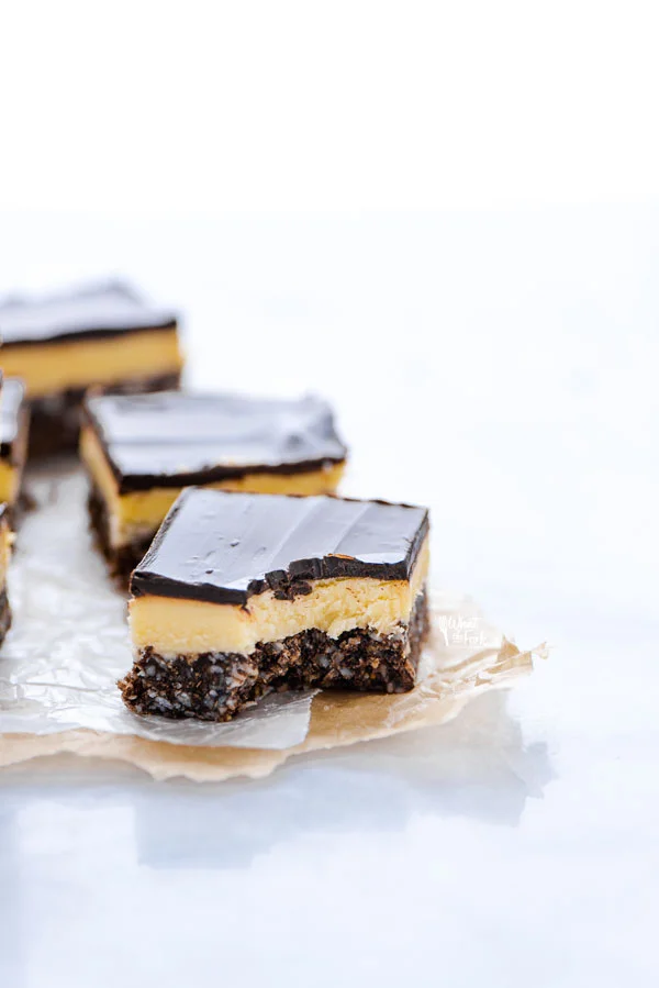 a gluten free Nanaimo Bar with a bite taken out