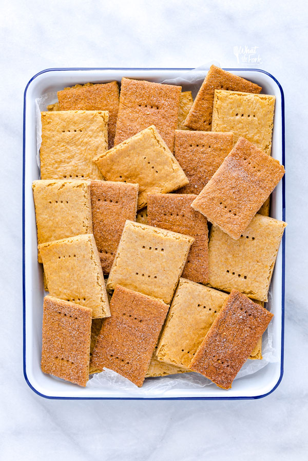 gluten free graham crackers arranged on a blue and white enamel baking tray