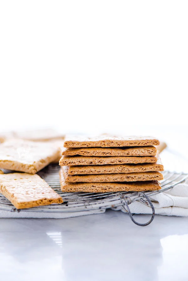 a stack of gluten free graham crackers on a round wire metal cooling rack