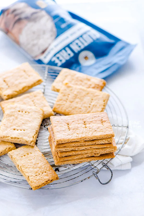 gluten free graham crackers on a round metal wire rack with a bag of King Arthur Gluten Free Measure for Measure Flour in the background