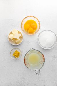 overhead shot of lemon curd ingredients in individual bowls