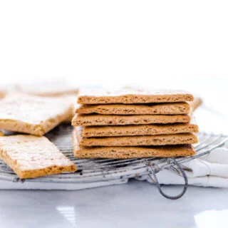 a stack of gluten free graham crackers on a round wire metal cooling rack