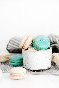 white and blue French Macarons in a small pottery bowl