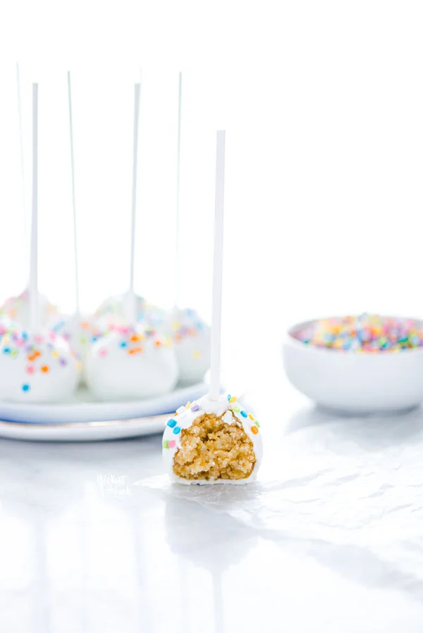 a gluten free confetti cake pop with a bite taken out