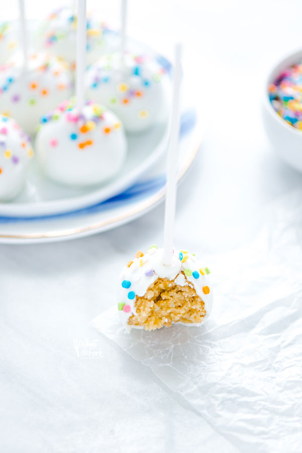a gluten free confetti cake pop with a bite taken out