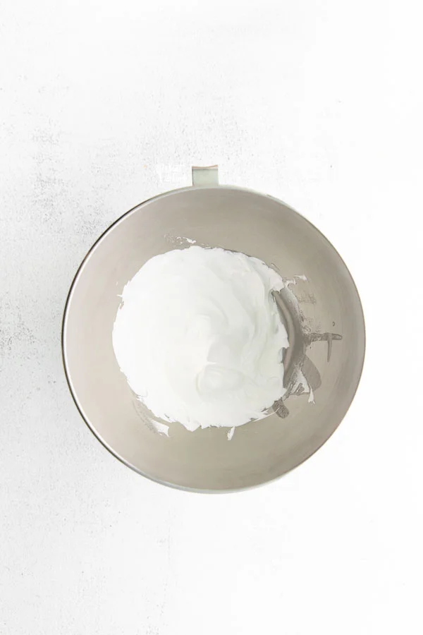 overhead shot of meringue in a large silver bowl