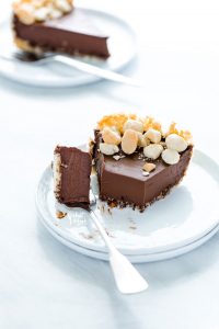 a slice of Macadamia Nut Chocolate Pie with Coconut Crust with a bite on a fork