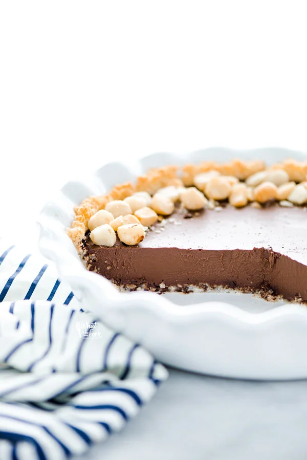 a Macadamia Nut Chocolate Pie with Coconut Crust that's been sliced into