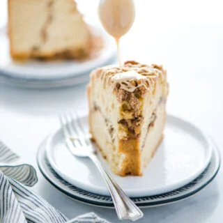 maple glaze being drizzled on a slice of gluten free sour cream coffee cake