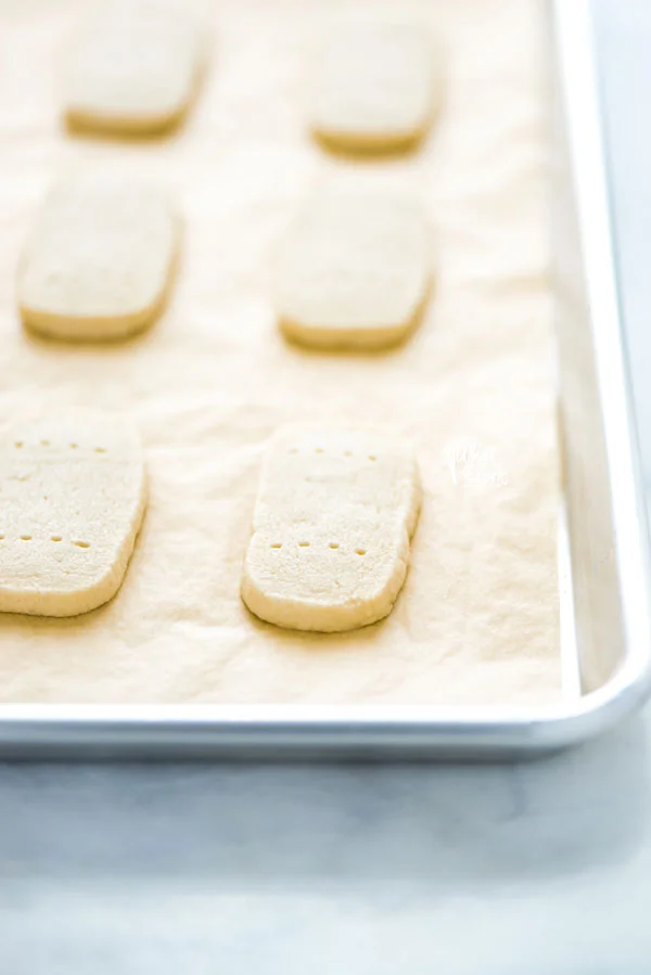 baked Gluten Free Shortbread Cookies on a metal sheet pan lined with natural parchment paper