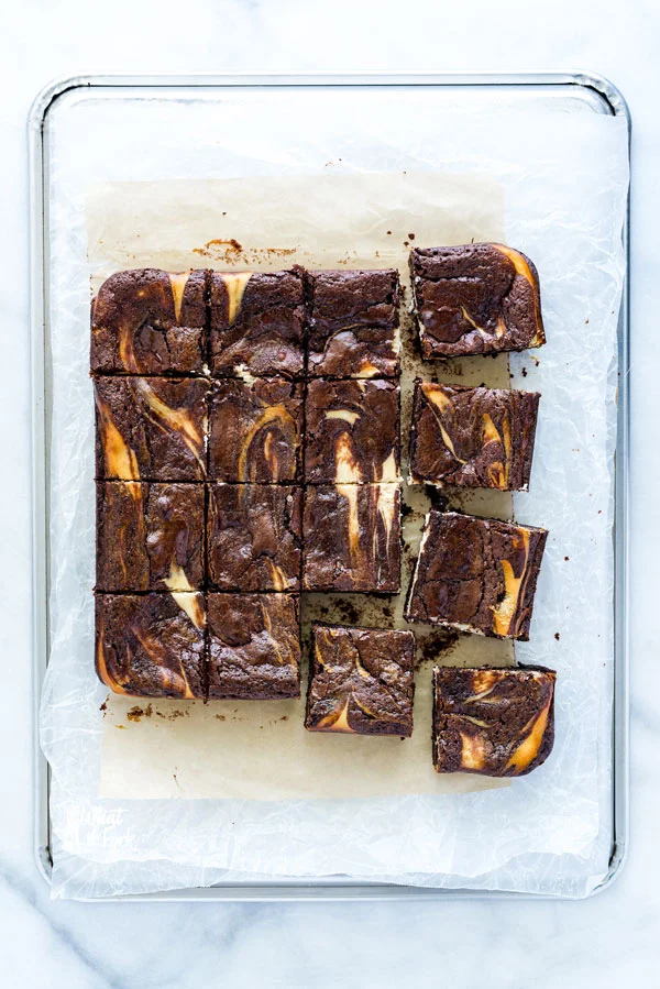 sliced Gluten Free Cheesecake Brownies on natural parchment paper