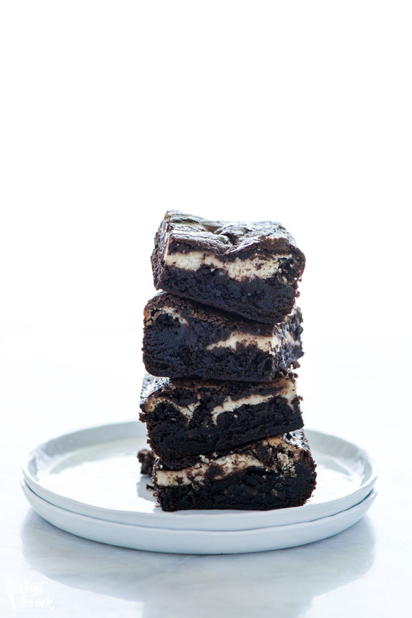a stack of Gluten Free Cheesecake Brownies on a white plate