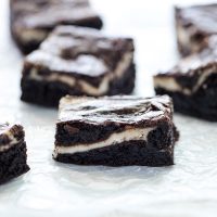 sliced Gluten Free Cheesecake Brownies on wax paper