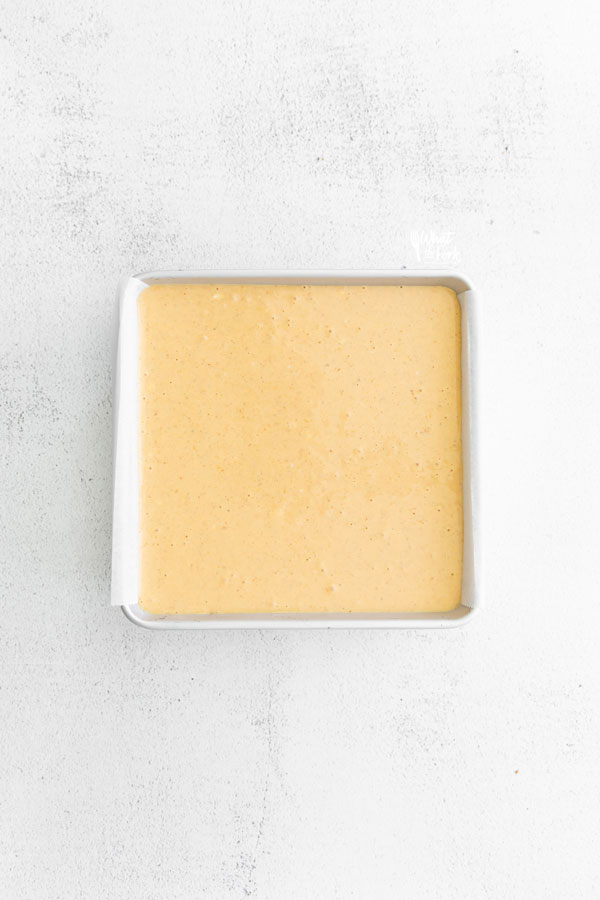 batter for Gluten Free Pumpkin Cheesecake Bars in a 9x9 square pan ready to be baked