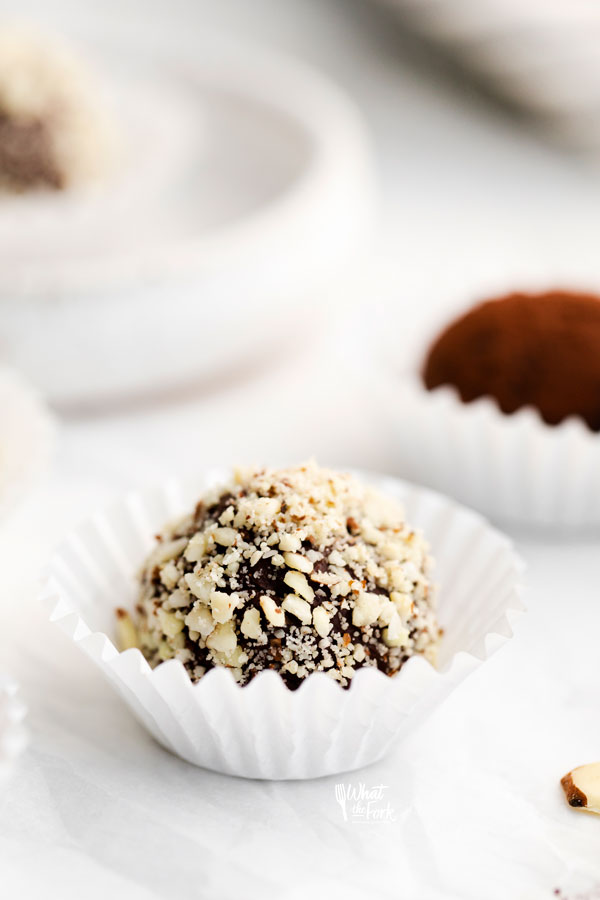 amaretto truffles in white paper liners rolled in minced almonds or cocoa powder