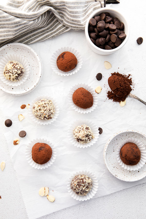 overhead shot of Amaretto Truffles in white paper liners rolled in cocoa powder or minced almonds