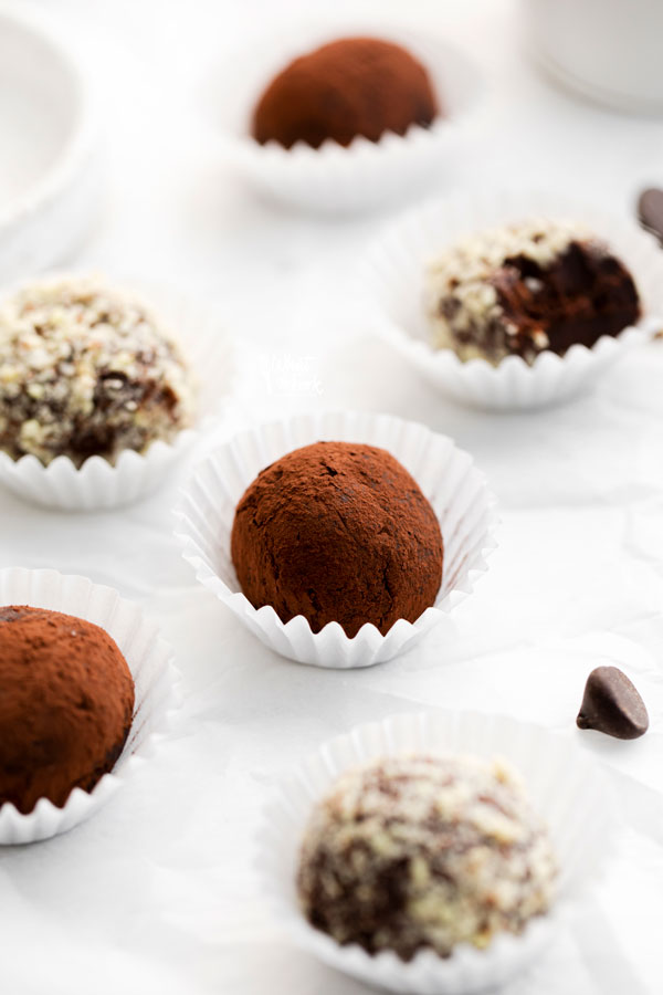 Amaretto Truffles in white paper liners rolled in cocoa powder and minced almonds