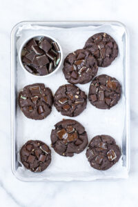 overhead shot of Gluten Free Andes Mint Chocolate Chip Cookies on parchment paper lined quarter sheet pan