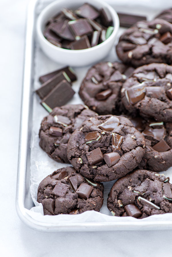 Gluten Free Andes Mint Chocolate Chip Cookies on a parchment paper lined quarter sheet pan