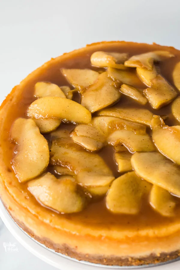 overhead angled shot of a gluten free caramel apple cheesecake showing the caramelized apples on top