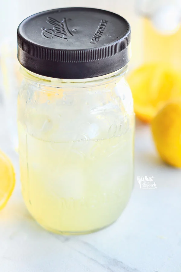 Non-Alcoholic Rosemary Citrus Spritzers being made in a mason jar shaker