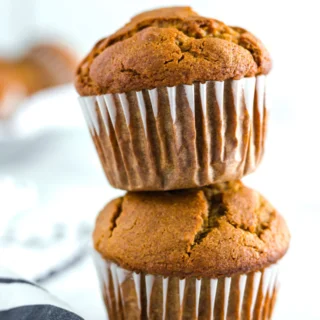 2 stacked gluten free pumpkin muffins made from a gluten free pumpkin muffin recipe