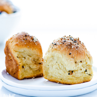 2 Gluten Free Rolls Recipe with Everything Bagel Seasoning on a stack of 2 white plates