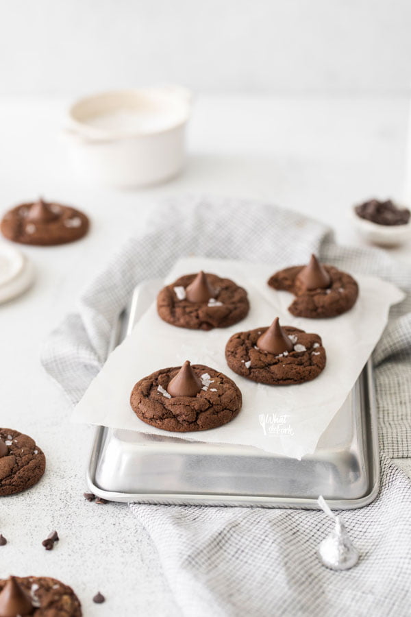 Gluten Free Hershey Kiss Cookies on an upside down quarter sheet pan lined with white parchment paper