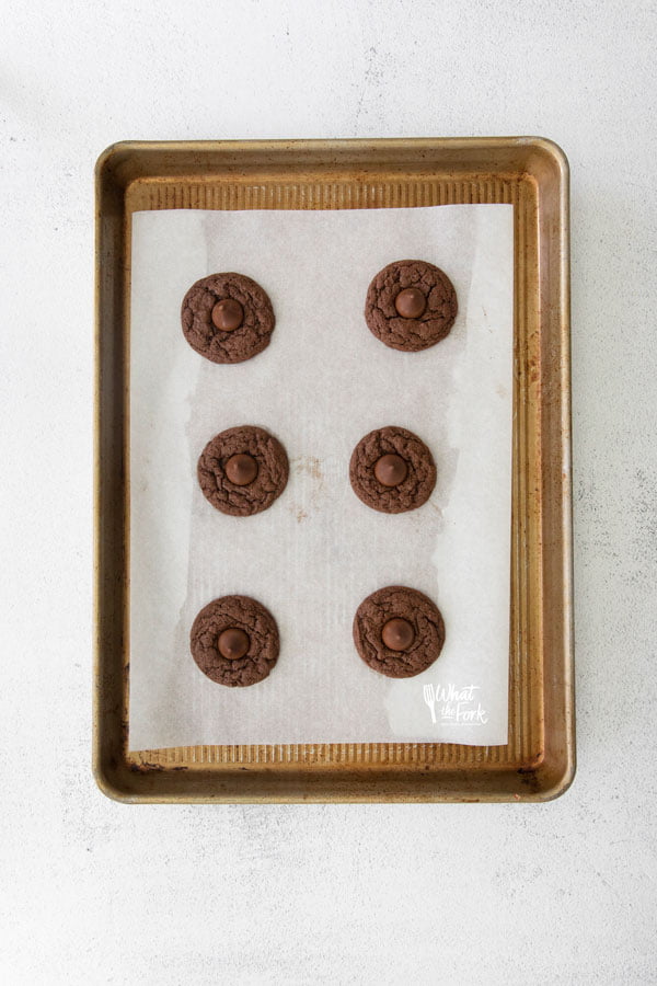 overhead shot of Gluten Free Hershey Kiss Cookies on a parchment paper lined half sheet pan