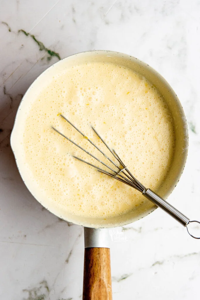 ingredients for lemon pudding in a pot whisked together