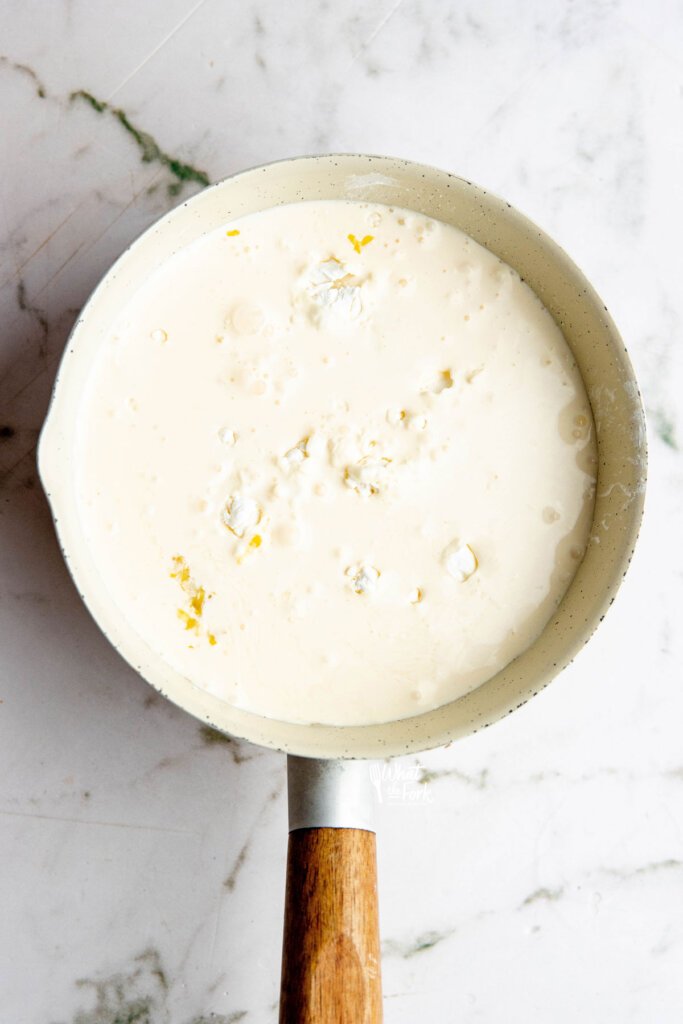 all ingredients to make an Easy Lemon Pudding Recipe in a white saucepan