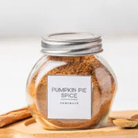 homemade pumpkin pie spice made and stored in a small glass jar with a metal twist top.