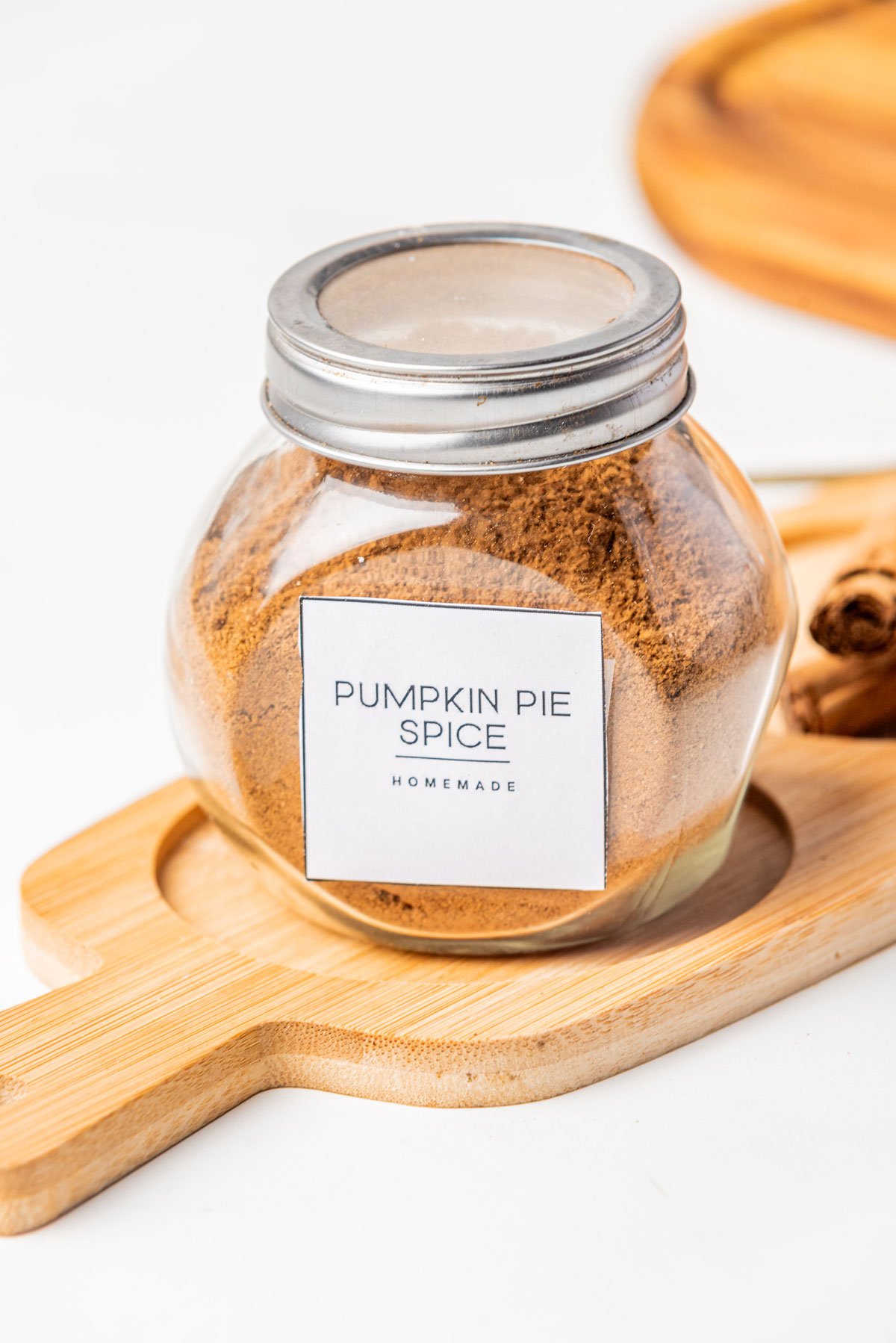 Homemade Pumpkin Pie Spice (Easy DIY Recipe) made and stored in a glass jar with a metal screw top lid and label