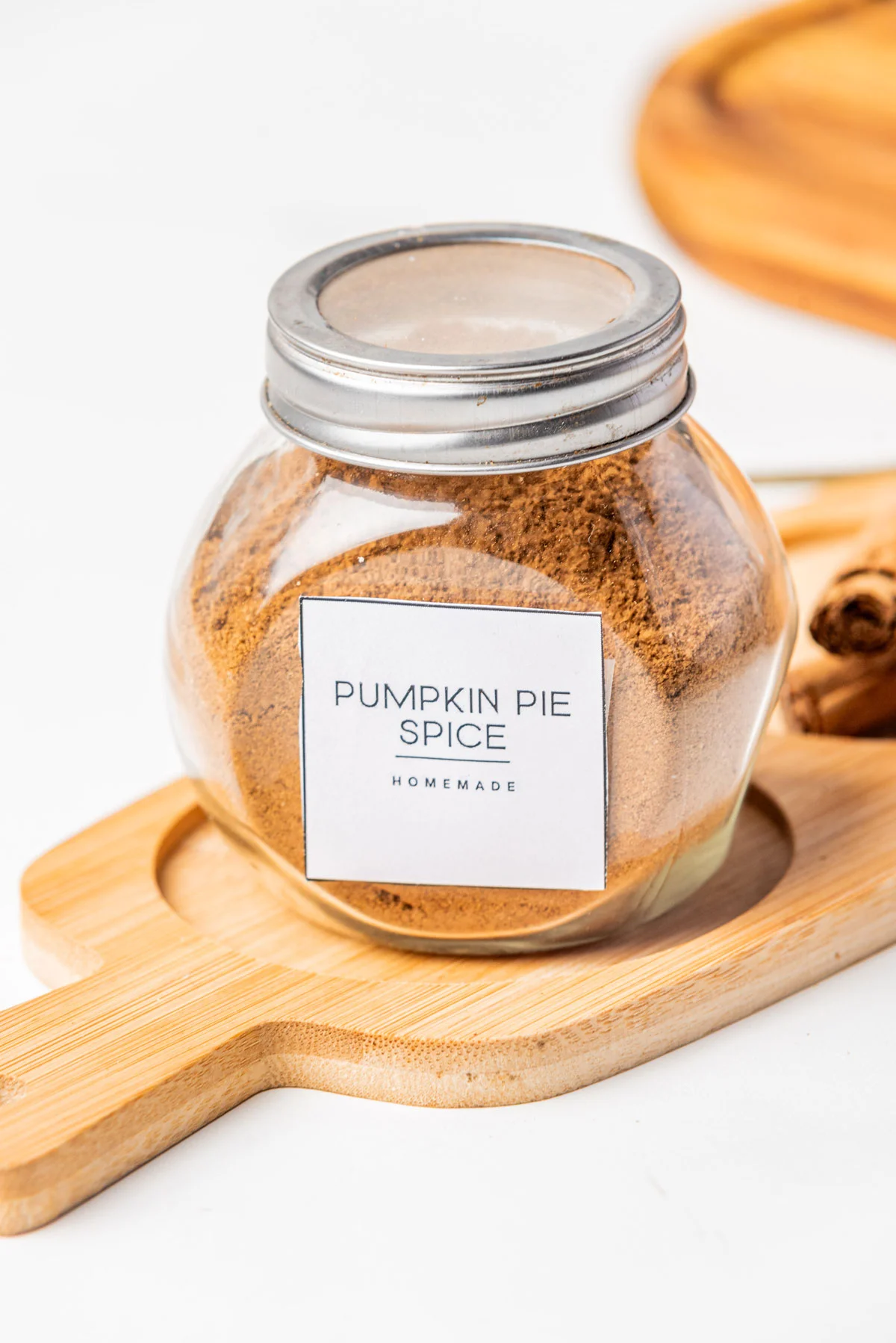 Homemade Pumpkin Pie Spice (Easy DIY Recipe) made and stored in a glass jar with a metal screw top lid and label