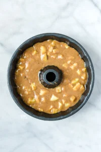 gluten free apple cake batter in bundt pan ready to bake