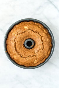 a baked gluten free apple cake in a bundt pan ready to cool