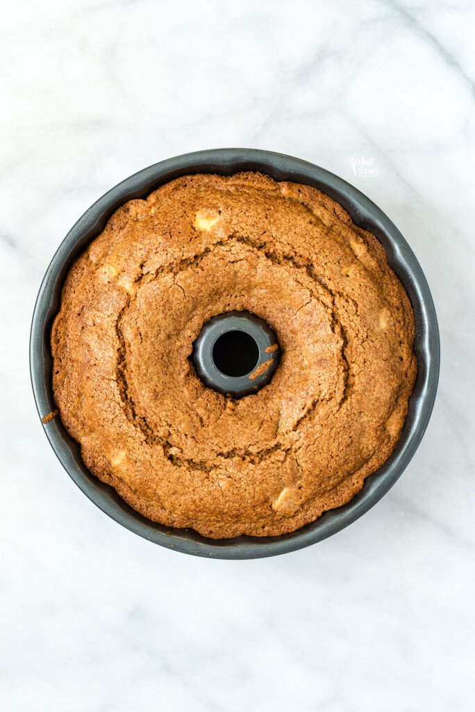 a baked gluten free apple cake in a bundt pan ready to cool