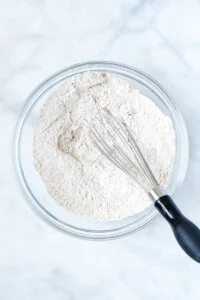 dry ingredients whisked together in a glass bowl to make gluten free apple cake