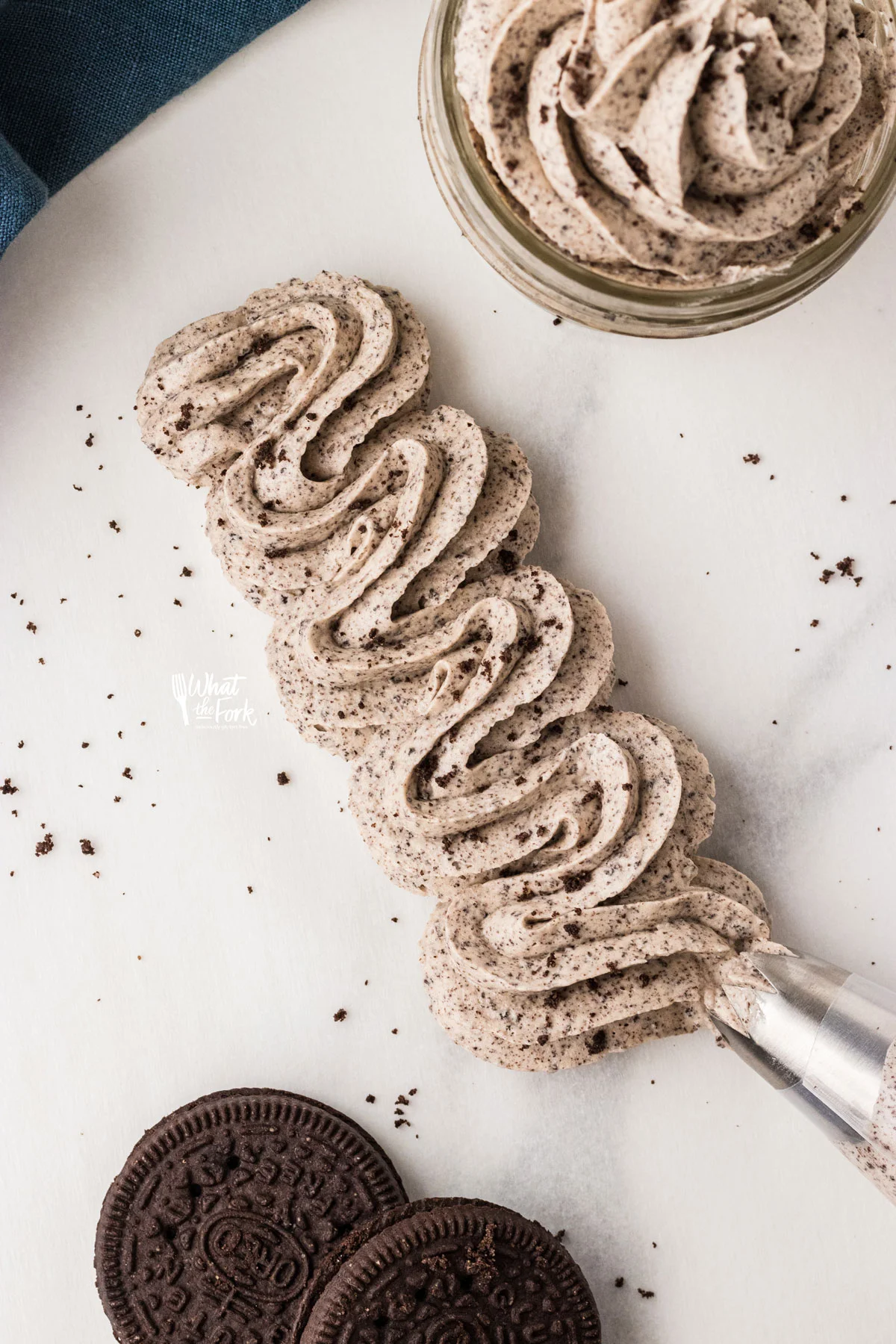 Cookies and Cream Frosting Recipe piped onto a flat surface with an open star tip.