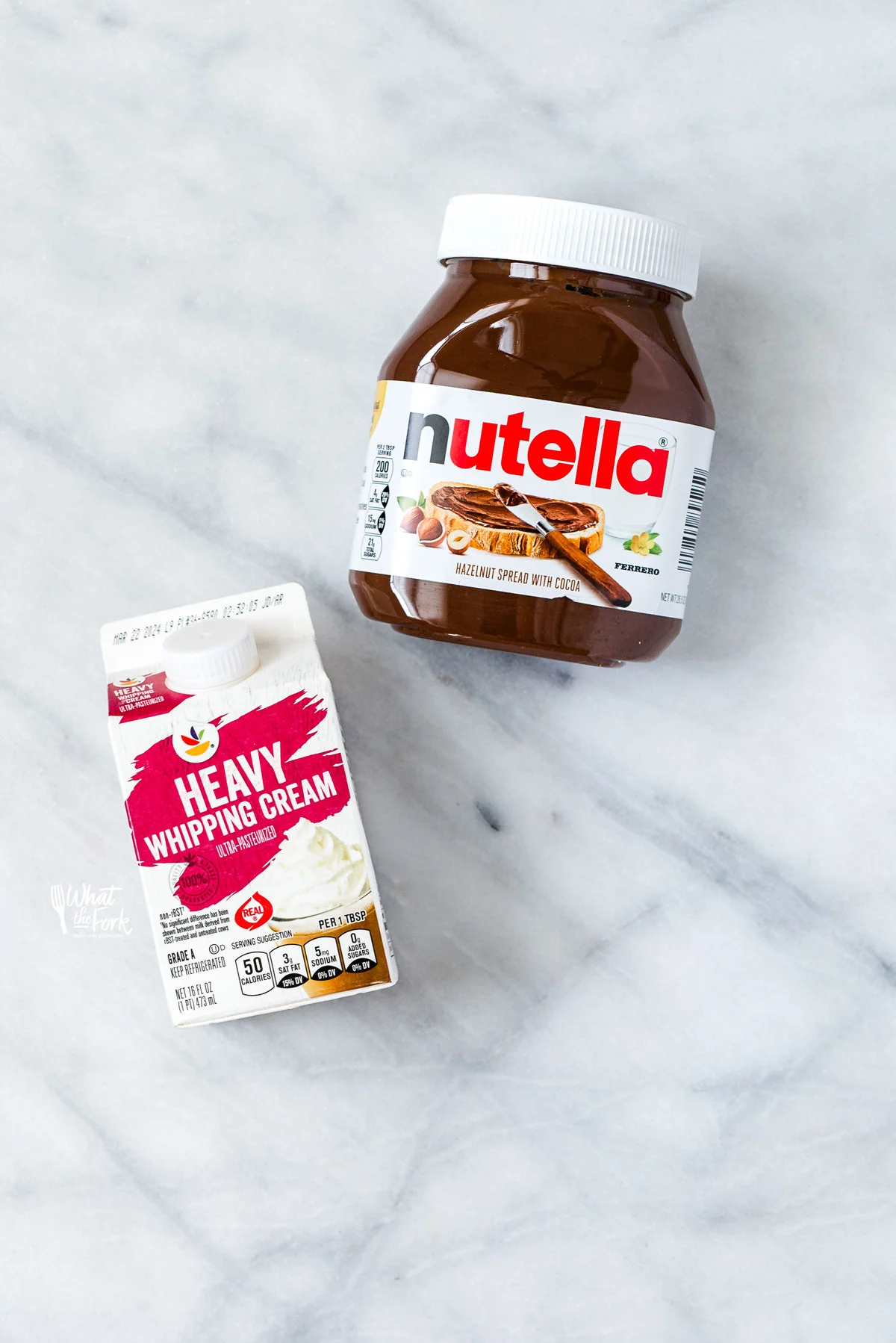 overhead shot of a jar of Nutella and a pint of Heavy Whipping Cream laid out to make Nutella Whipped Cream