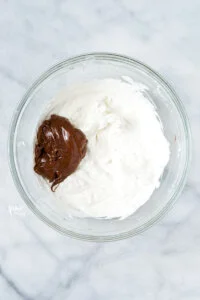nutella in a large, clear glass bowl with whipped cream
