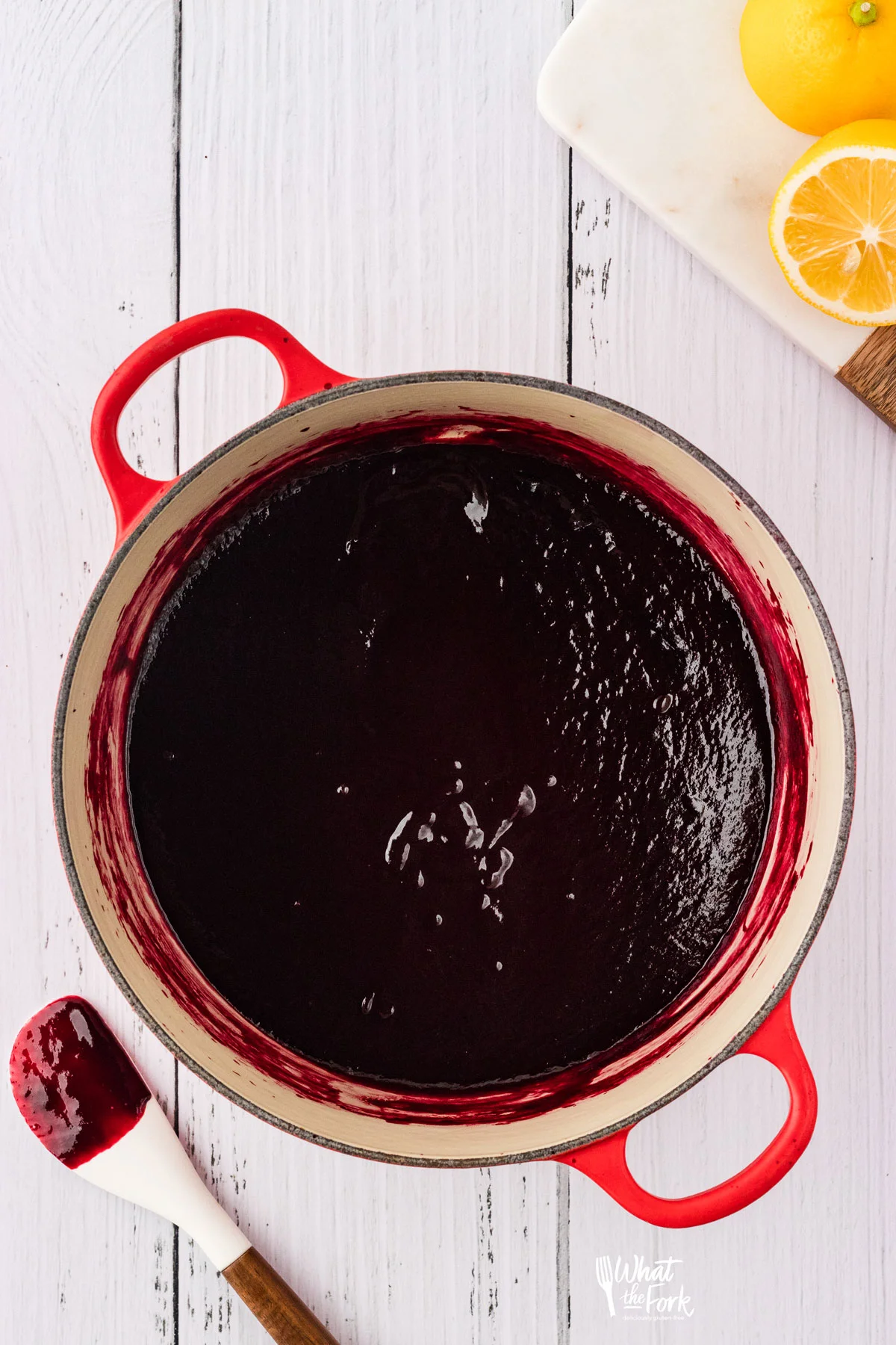 overhead shot of cooked blackberry cake filling in a red Le Creuset pot