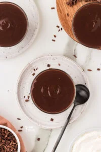 overhead shot of chocolate pudding in small glass cups ready to be served