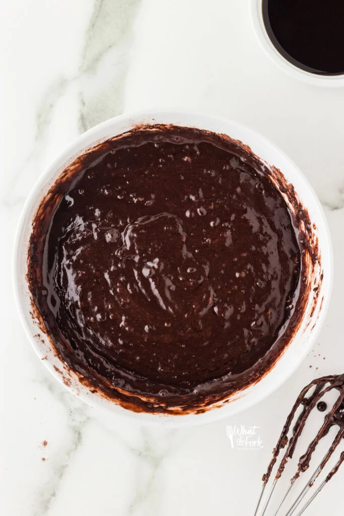 mixed chocolate cupcake batter in a large white mixing bowl